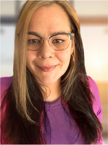 Woman with brown hair and glasses smiling.